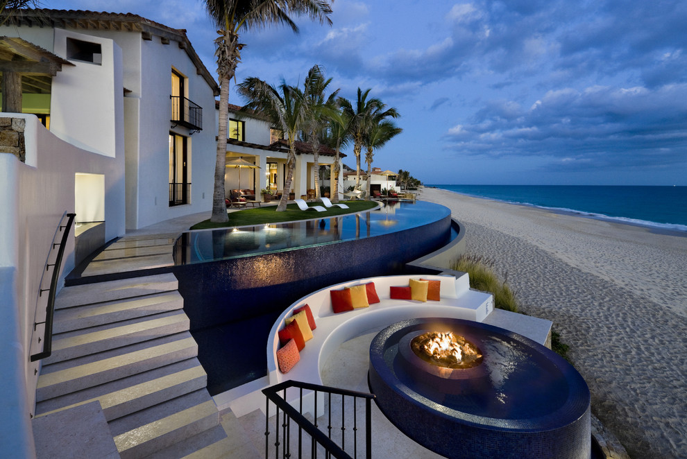 Pool - large tropical backyard concrete paver and custom-shaped infinity pool idea in Mexico City