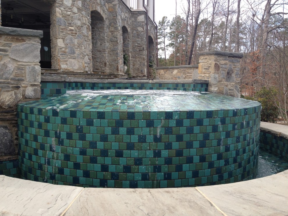 Mid-sized arts and crafts backyard stone and custom-shaped lap pool fountain photo in Other