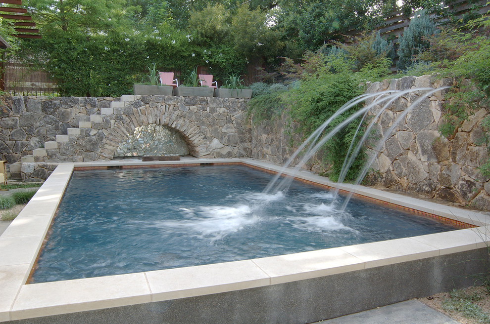 Photo of a traditional rectangular swimming pool in Austin with a water feature.