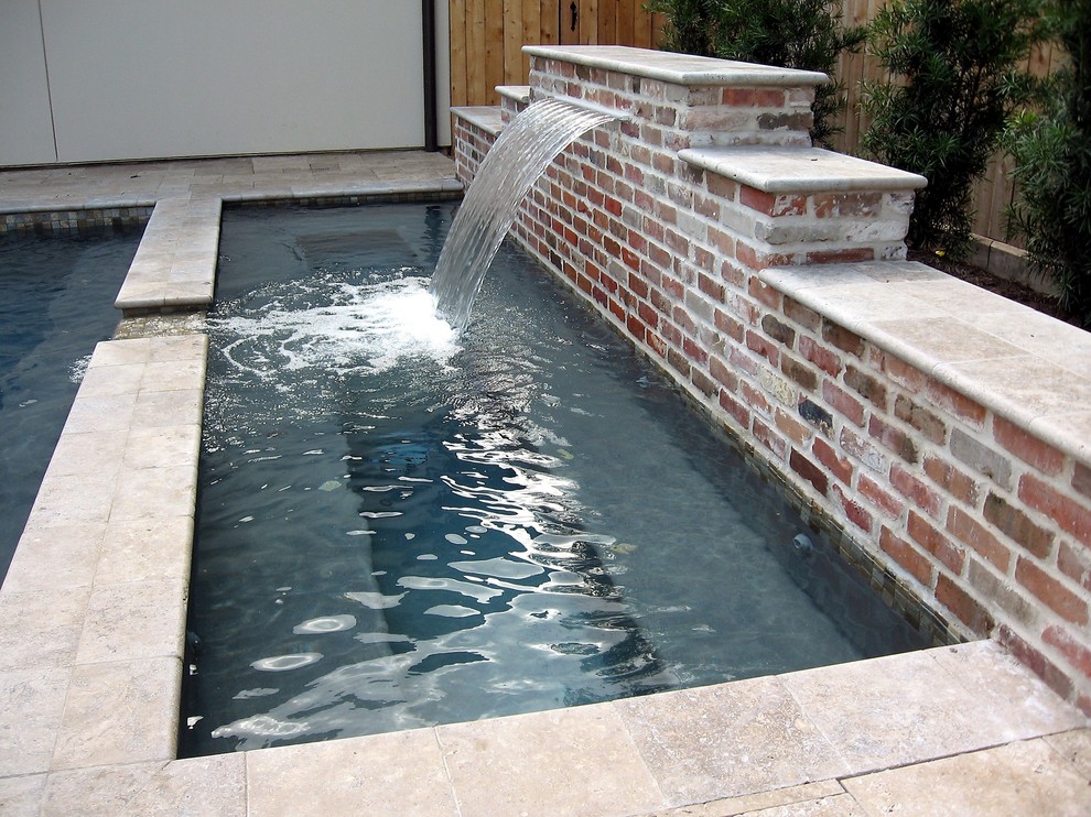 Inspiration for a medium sized classic back rectangular lengths swimming pool in Houston with a water feature and tiled flooring.