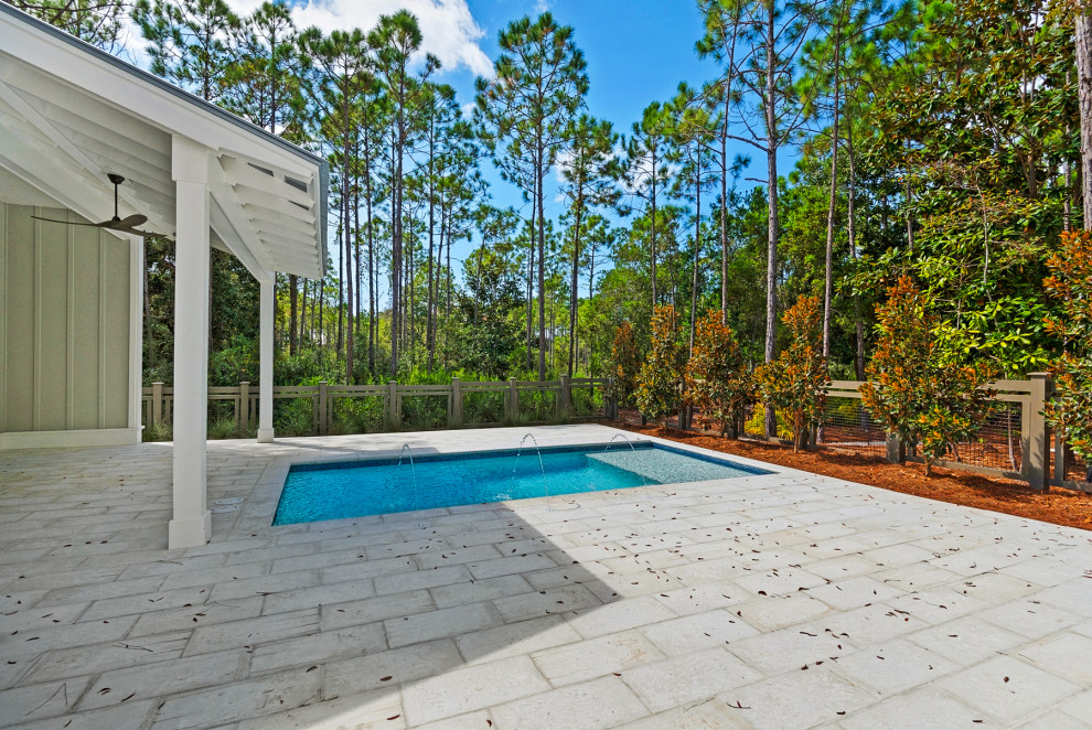 Small minimalist backyard concrete paver and rectangular pool photo in Miami