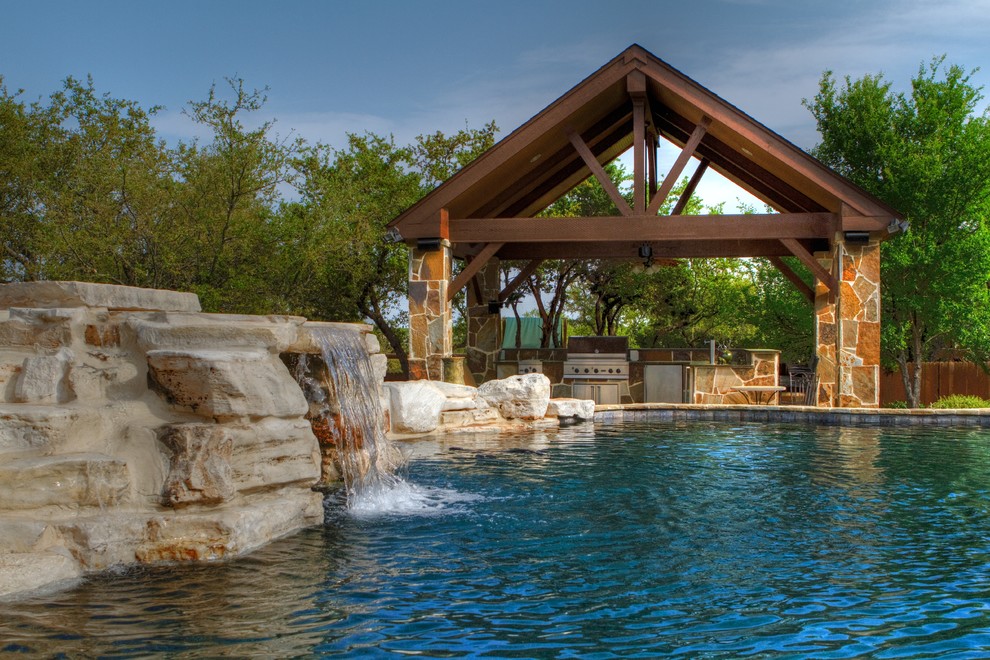 Design ideas for a medium sized traditional back custom shaped natural hot tub in Austin with natural stone paving.