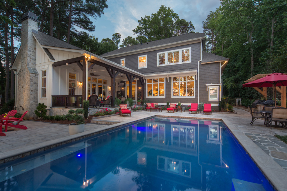 Large farmhouse backyard rectangular and stone lap pool photo in Charlotte