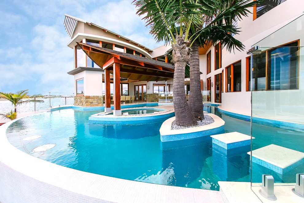 Design ideas for a world-inspired custom shaped swimming pool in Sunshine Coast.