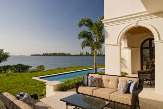 Example of a mid-sized backyard stone and rectangular natural pool design in Miami