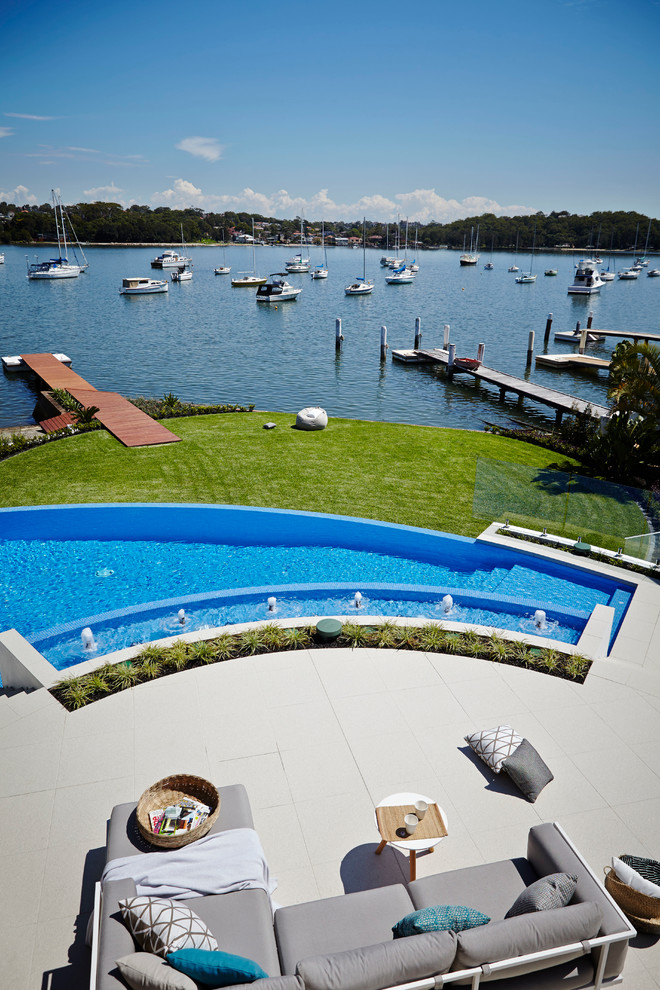 This is an example of a contemporary custom shaped infinity swimming pool in Sydney.