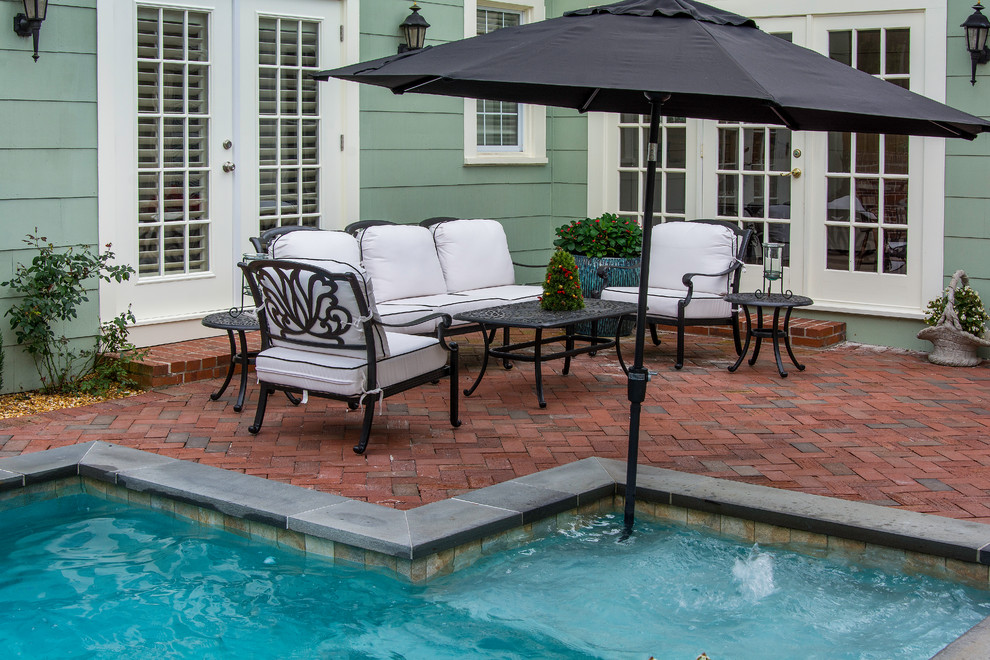 Inspiration for a small timeless backyard brick and custom-shaped natural hot tub remodel in Tampa
