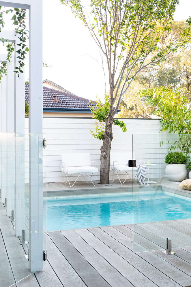 Inspiration for a small coastal backyard pool remodel in Perth with decking