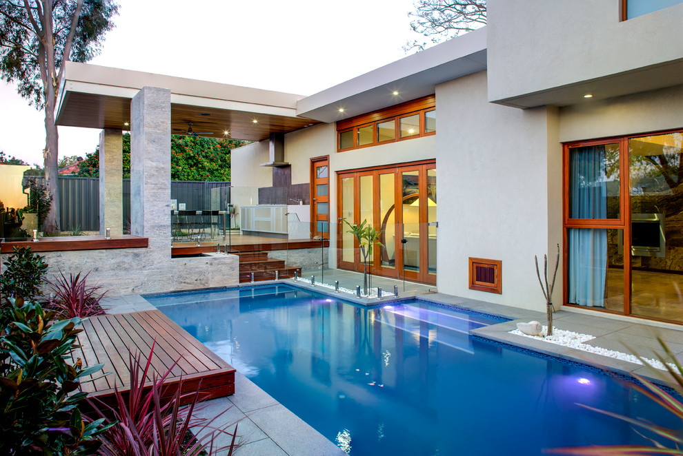 Photo of a contemporary rectangular swimming pool in Perth with concrete paving.