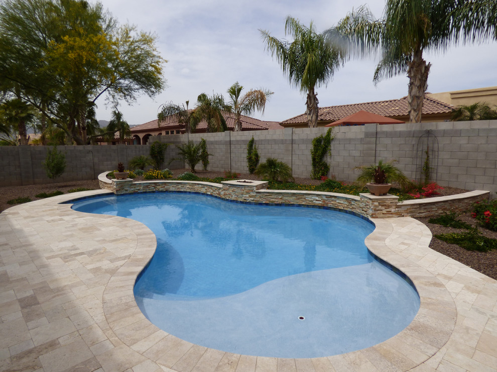Diseño de piscina con fuente alargada actual de tamaño medio a medida en patio trasero con suelo de baldosas