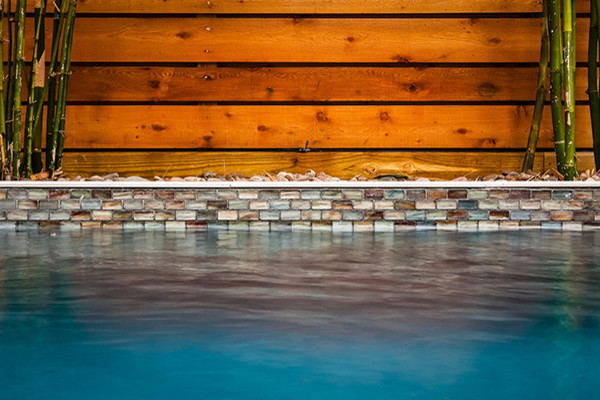 На фото: спортивный, прямоугольный бассейн среднего размера на заднем дворе в современном стиле с фонтаном и мощением тротуарной плиткой с