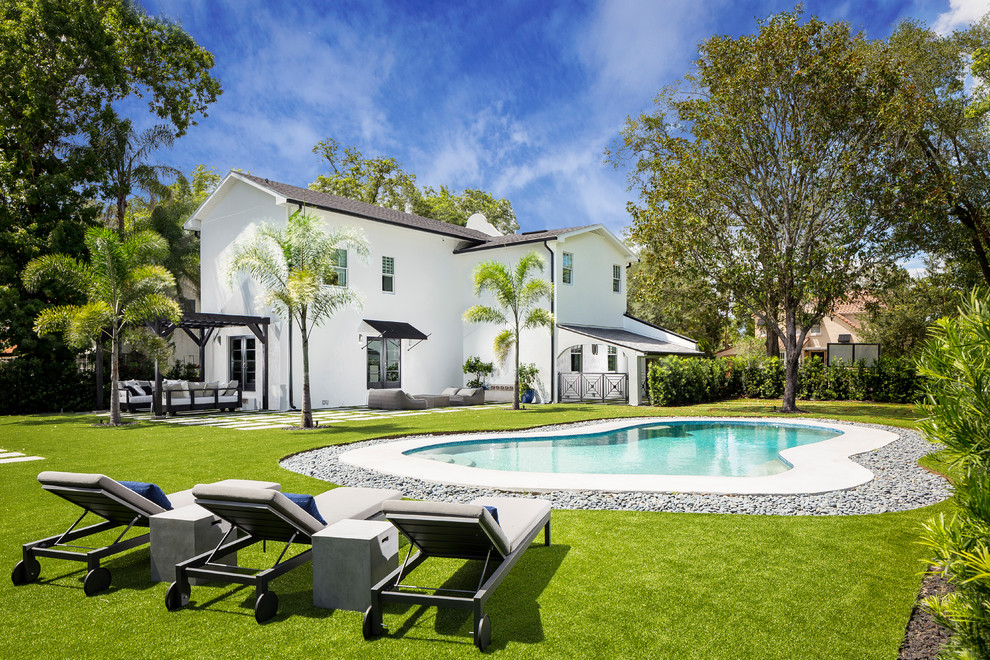 Transitional backyard custom-shaped pool photo in Orlando