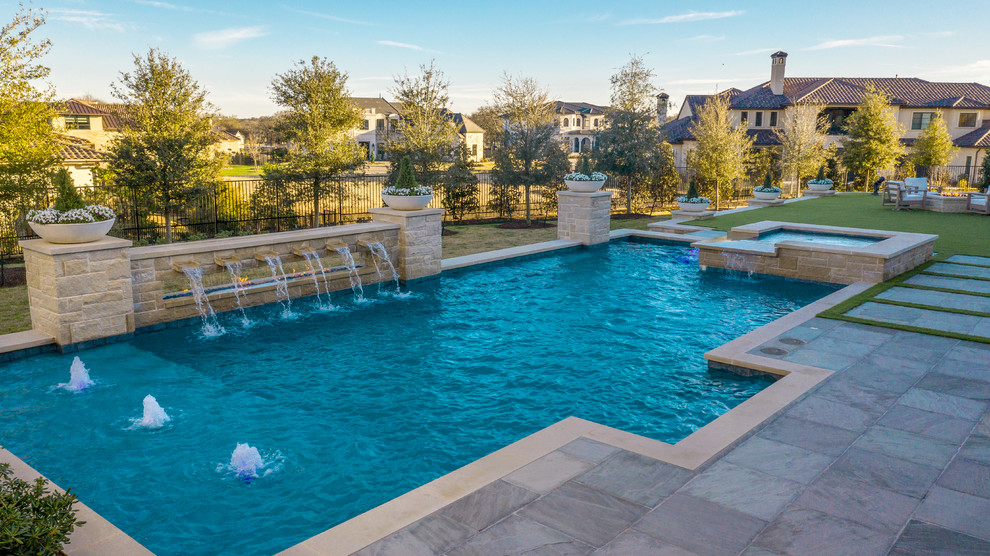 Large trendy backyard stone and rectangular lap pool fountain photo in Dallas
