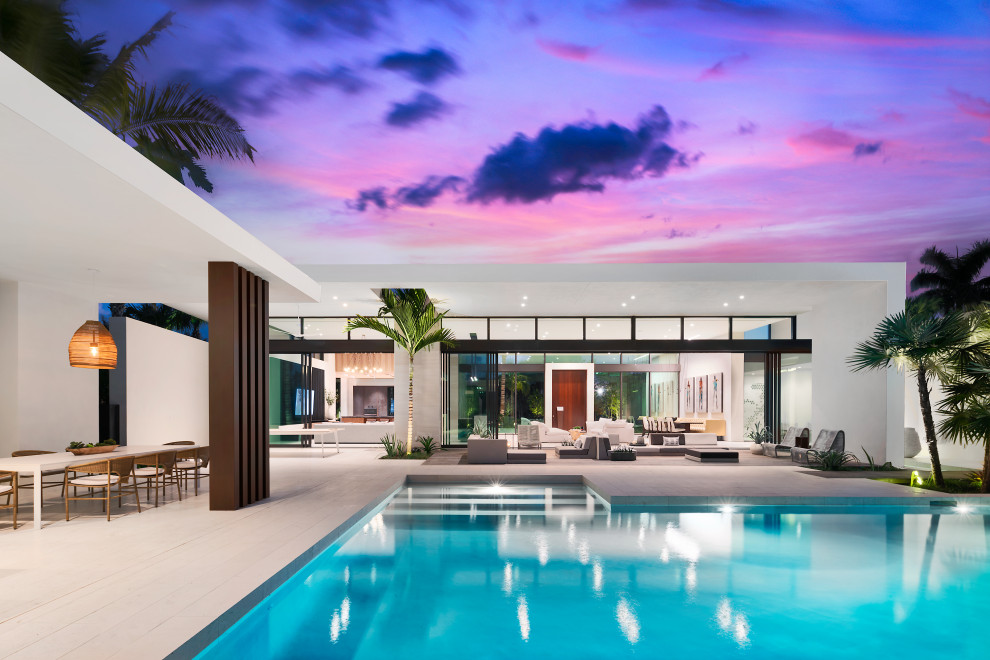 Large mid-century modern backyard custom-shaped hot tub photo in Miami