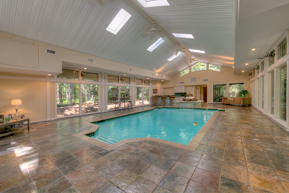 Photo of a large traditional indoor rectangular natural swimming pool in Houston with a pool house.