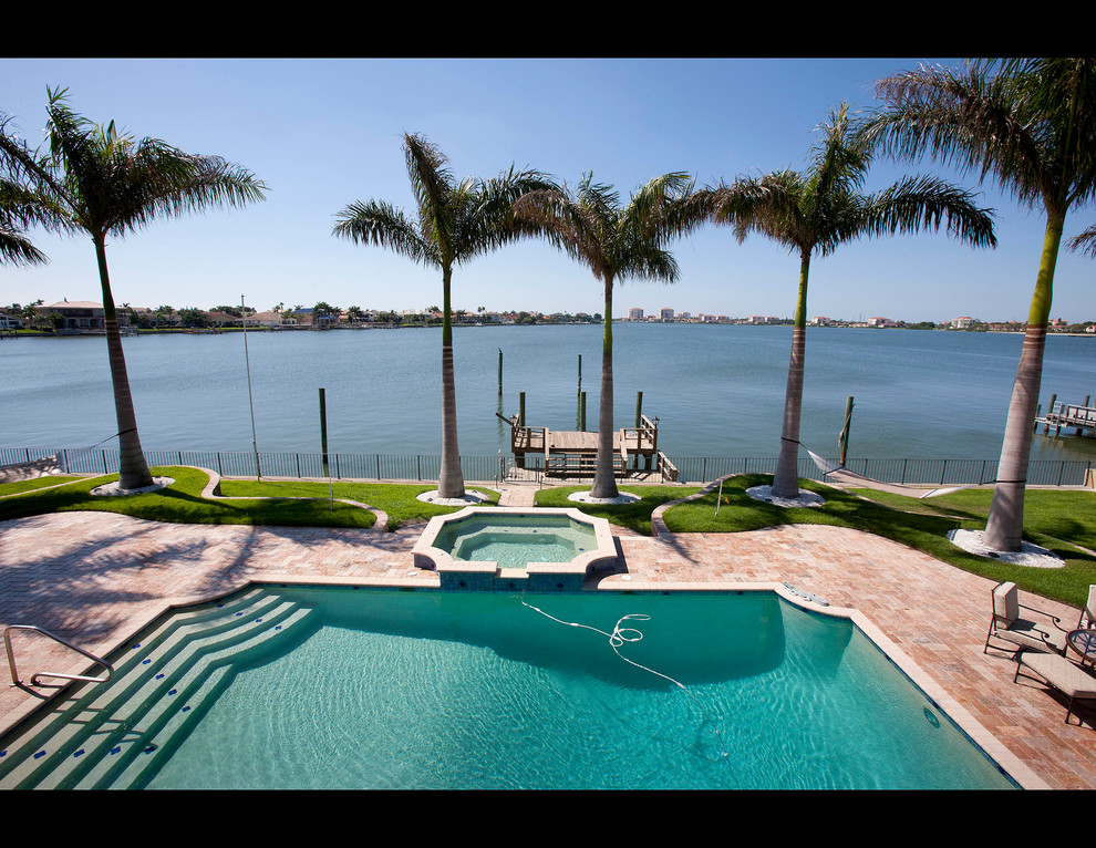 Inspiration for a large timeless backyard tile and rectangular lap hot tub remodel in Tampa