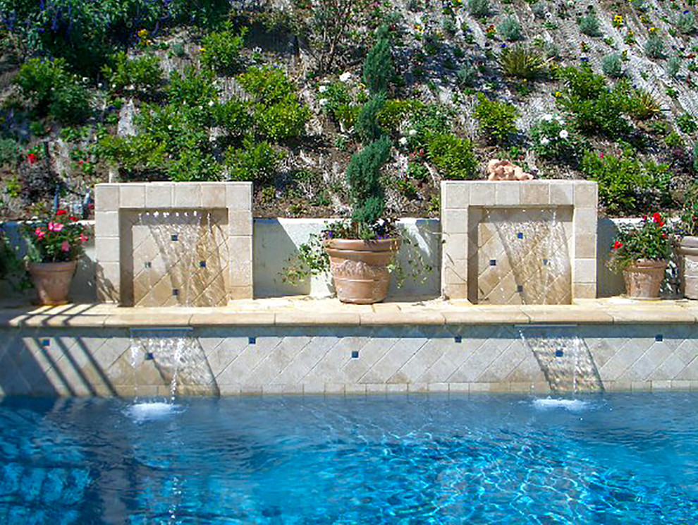 Foto de piscina con fuente alargada romántica de tamaño medio en forma de L en patio trasero con suelo de baldosas