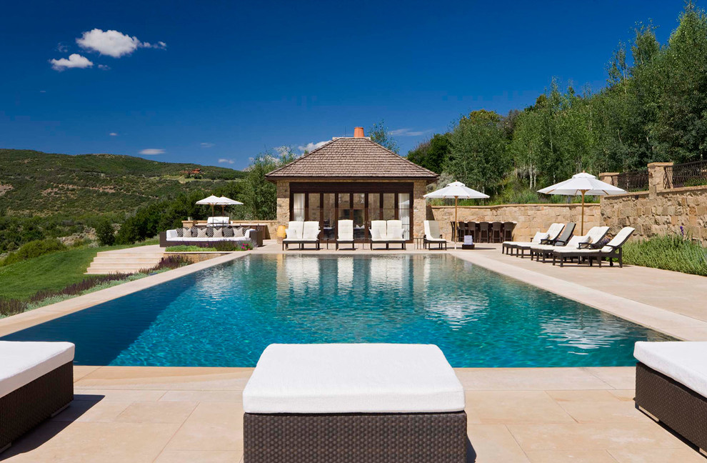 Inspiration for a large timeless backyard rectangular and concrete paver lap pool house remodel in Denver
