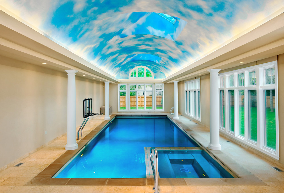 Ispirazione per una piscina coperta chic rettangolare di medie dimensioni con pavimentazioni in pietra naturale e una vasca idromassaggio
