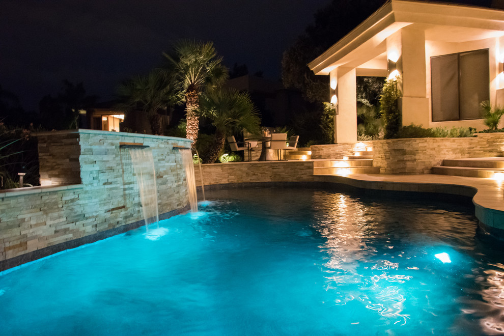 Example of a mid-sized eclectic backyard stone and custom-shaped hot tub design in Phoenix