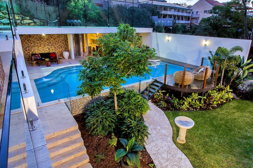 Inspiration for a mid-sized tropical backyard stone and custom-shaped infinity pool house remodel in Brisbane