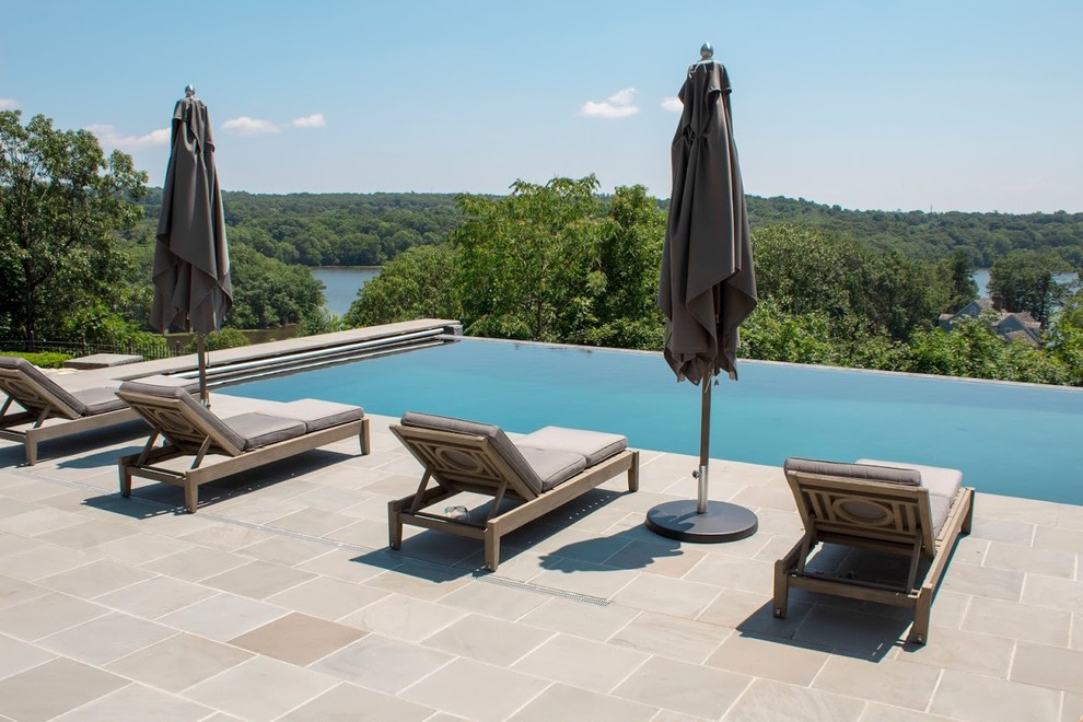 Inspiration for a small modern back rectangular infinity swimming pool in Boston with decking.