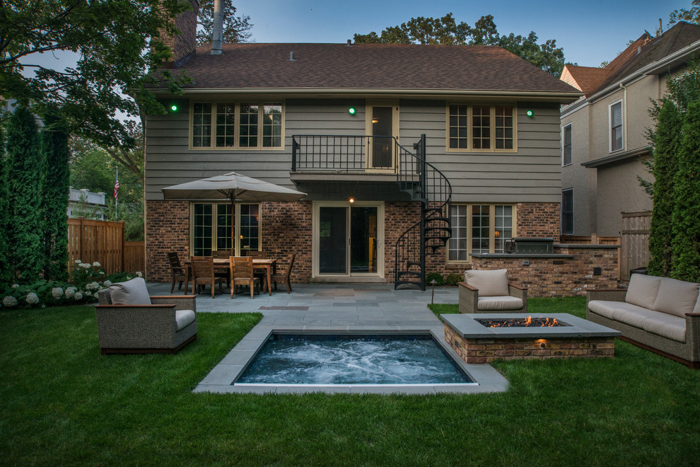 Immagine di una piccola piscina tradizionale rettangolare dietro casa con una vasca idromassaggio e pavimentazioni in pietra naturale