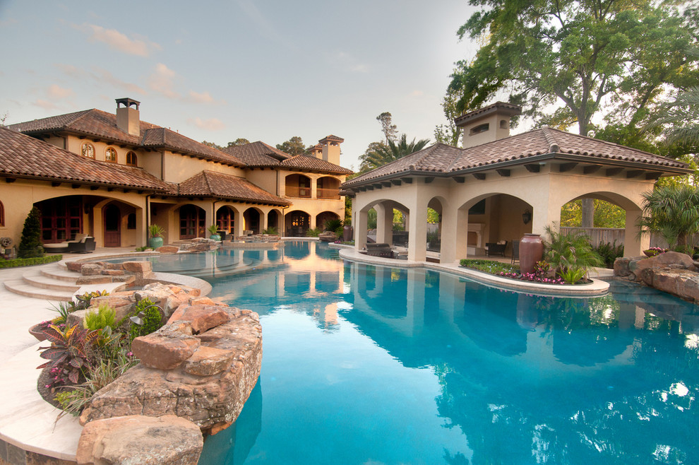 Design ideas for an expansive mediterranean custom shaped swimming pool in Phoenix.