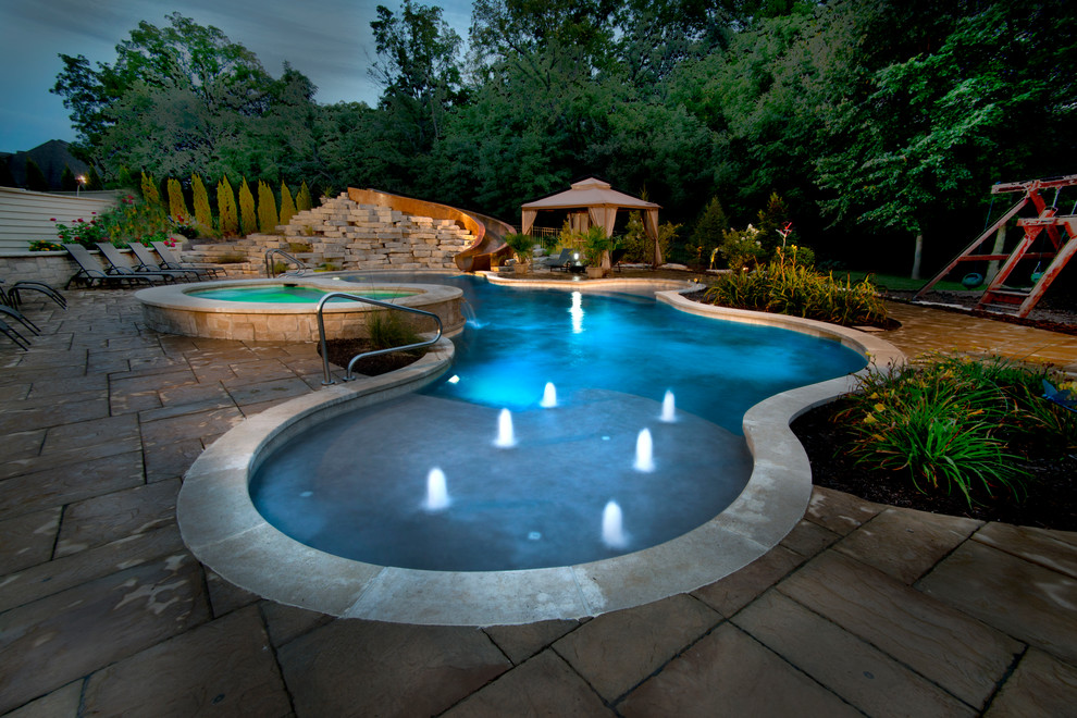 Mid-sized elegant backyard concrete paver and custom-shaped natural hot tub photo in Chicago
