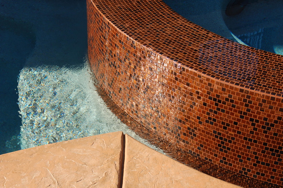 Mid-sized trendy backyard stamped concrete and custom-shaped hot tub photo in Sacramento