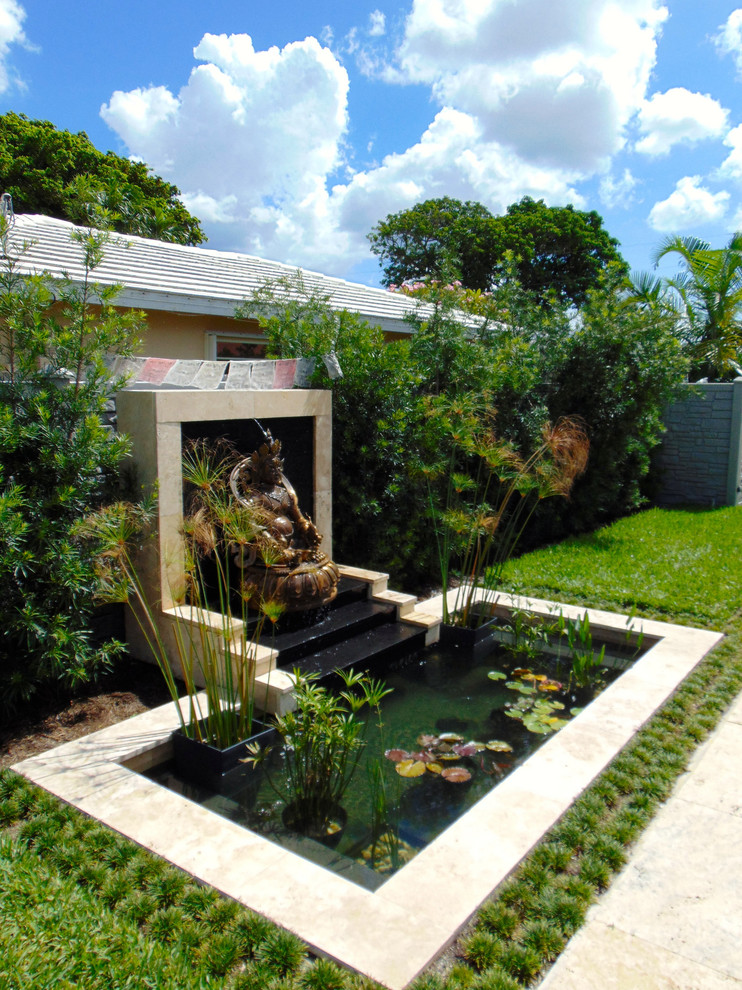 Modelo de piscina con fuente natural asiática pequeña a medida en patio trasero con adoquines de piedra natural