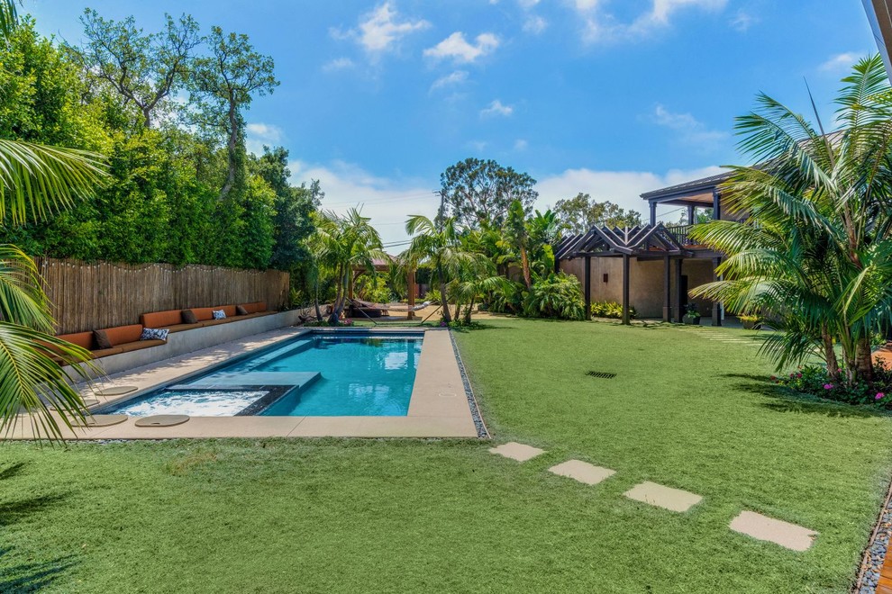 Pool - mid-sized tropical side yard concrete paver and rectangular lap pool idea in Los Angeles