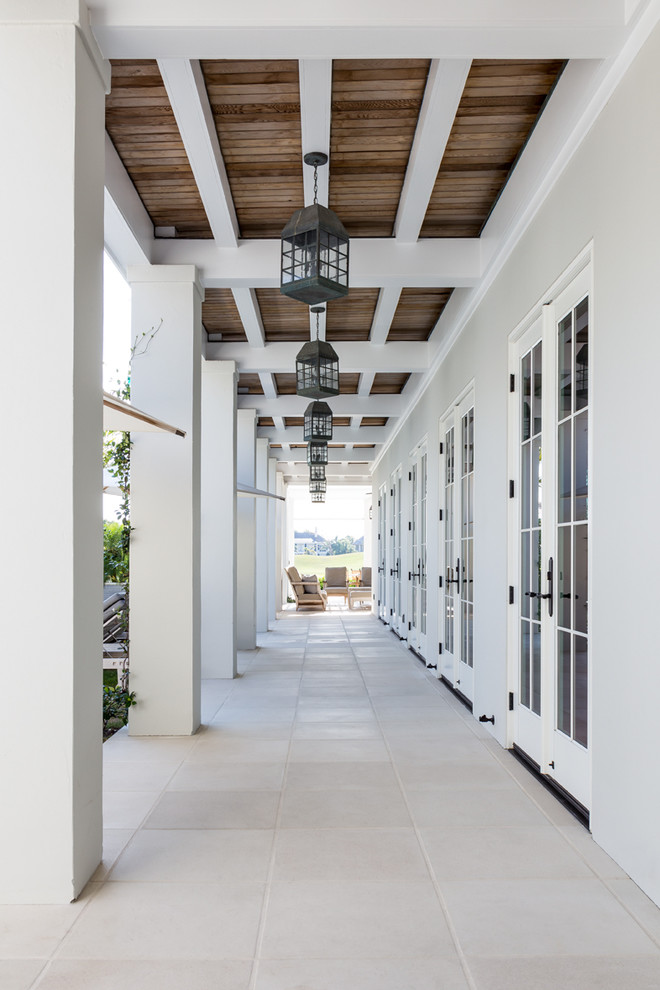 Elegant back porch photo in Miami with a roof extension