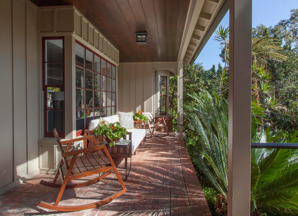 Photo of a traditional front veranda in San Diego with brick paving and a roof extension.