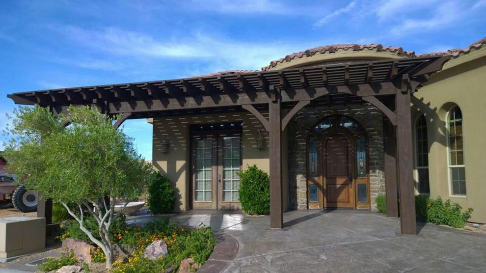 Inspiration for a mid-sized mediterranean concrete front porch remodel in Salt Lake City with a pergola
