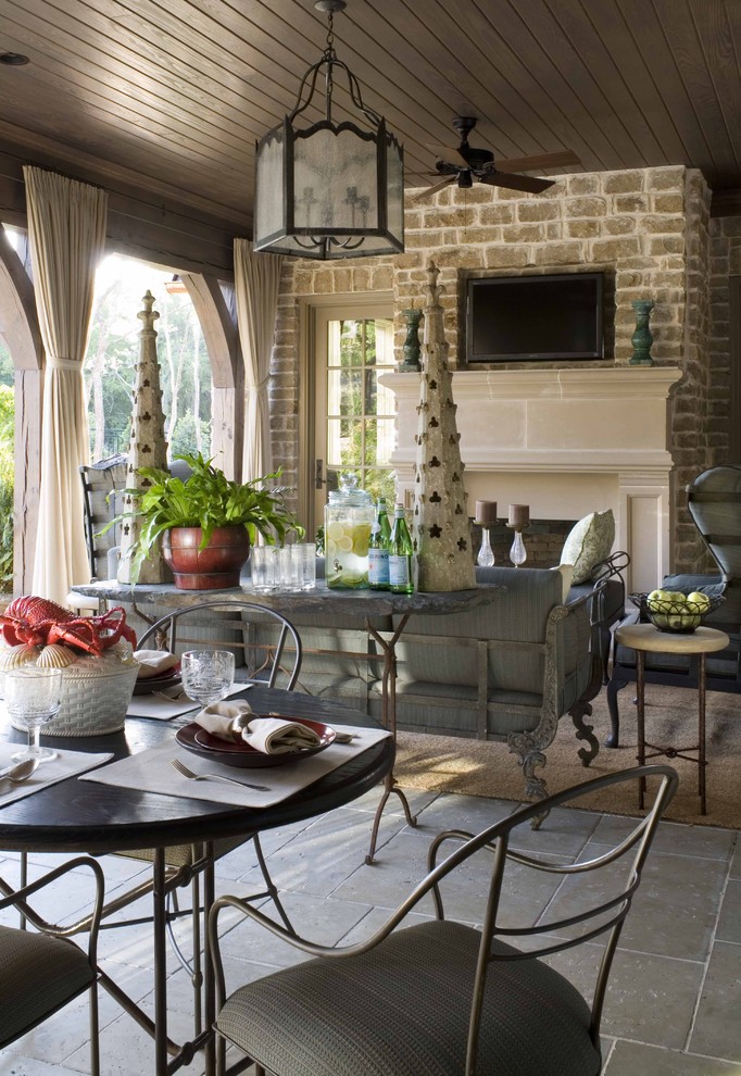 Inspiration for a timeless porch remodel in Dallas with a fire pit and a roof extension