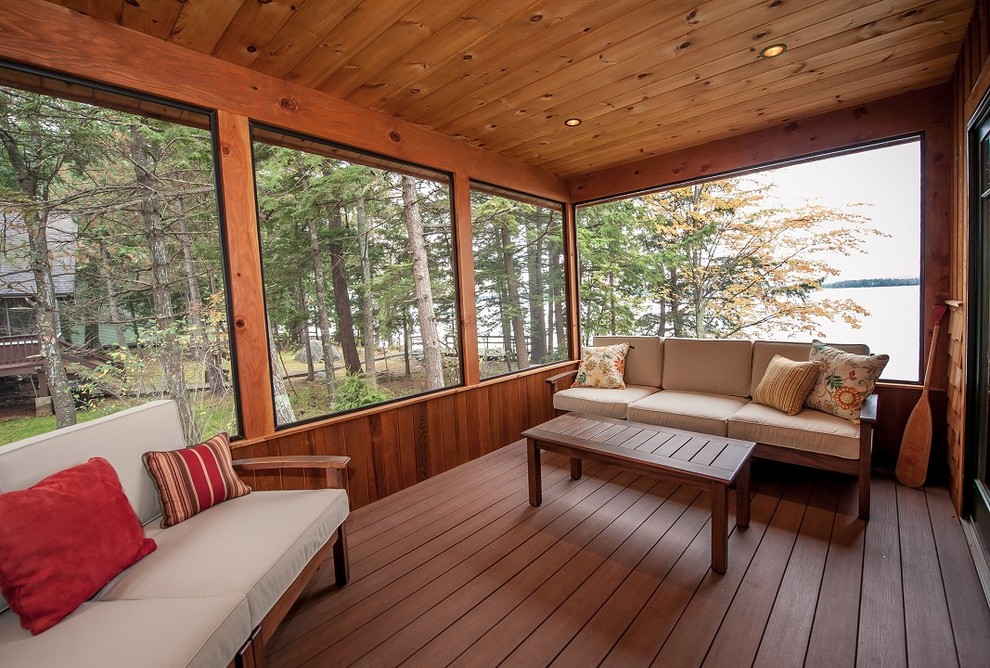 Mid-sized mountain style screened-in side porch photo in Portland Maine with decking and a roof extension