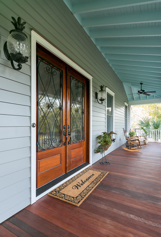 This is an example of a traditional front yard verandah in Charleston with a roof extension and wood railing.