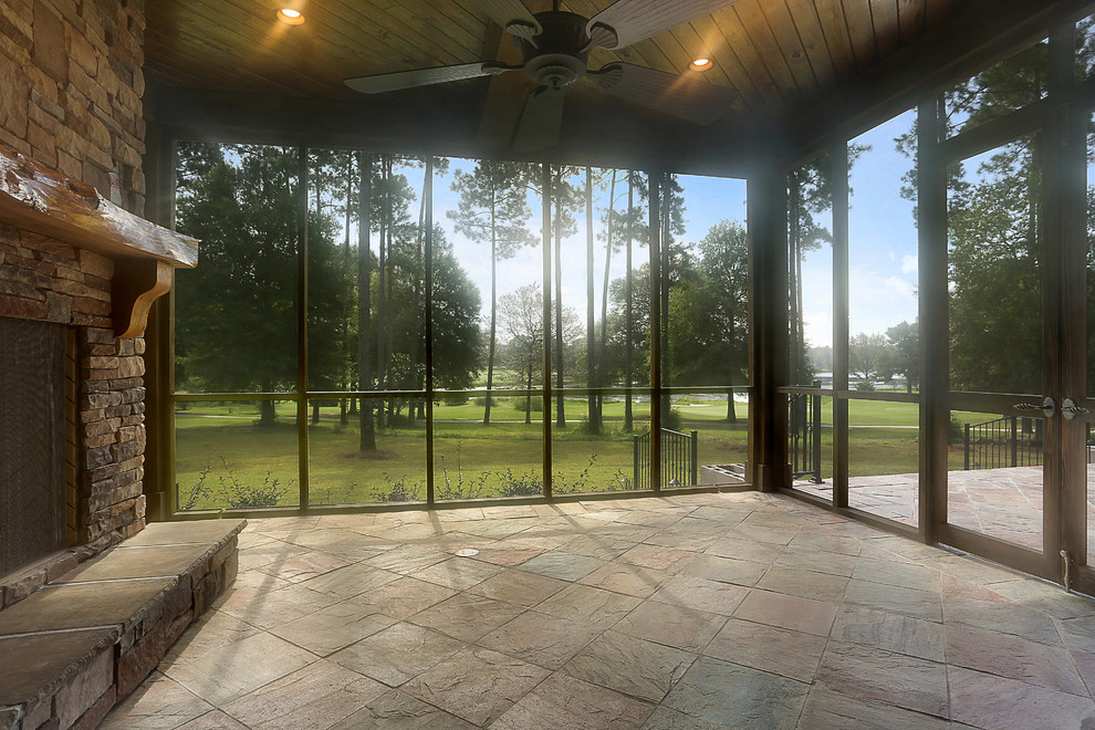 Inspiration for a timeless tile screened-in back porch remodel in New Orleans with a roof extension