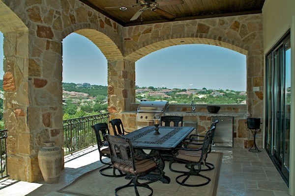 Mid-sized tuscan tile porch photo in Austin with a roof extension