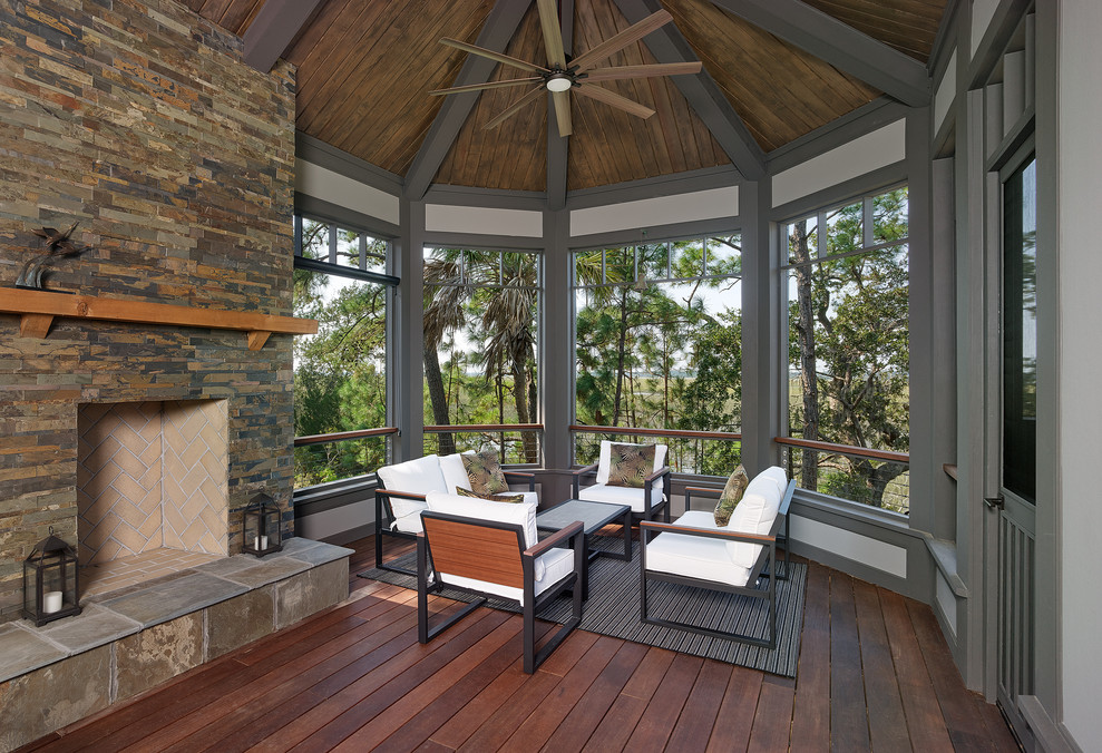 Large beach style screened-in porch idea in Charleston with decking and a roof extension