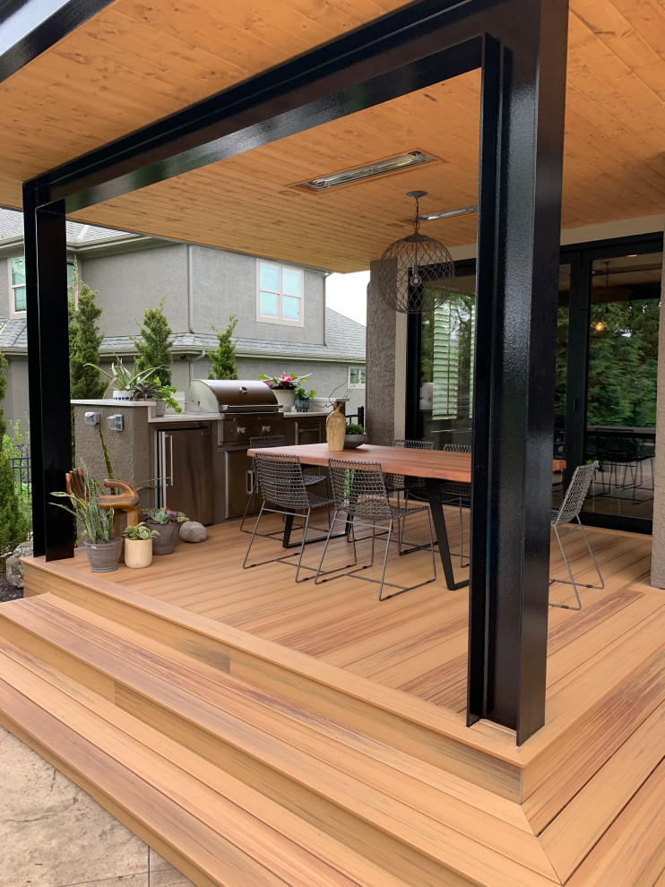 Inspiration for a small modern back veranda in Kansas City with an outdoor kitchen, decking and a roof extension.