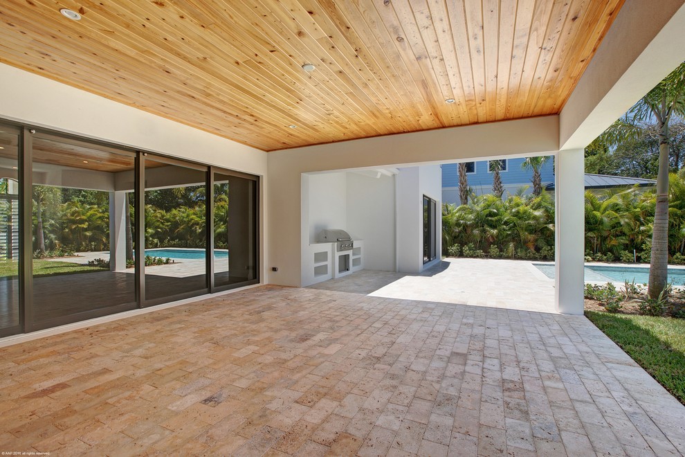 Photo of a medium sized mediterranean back veranda in Miami with an outdoor kitchen and tiled flooring.