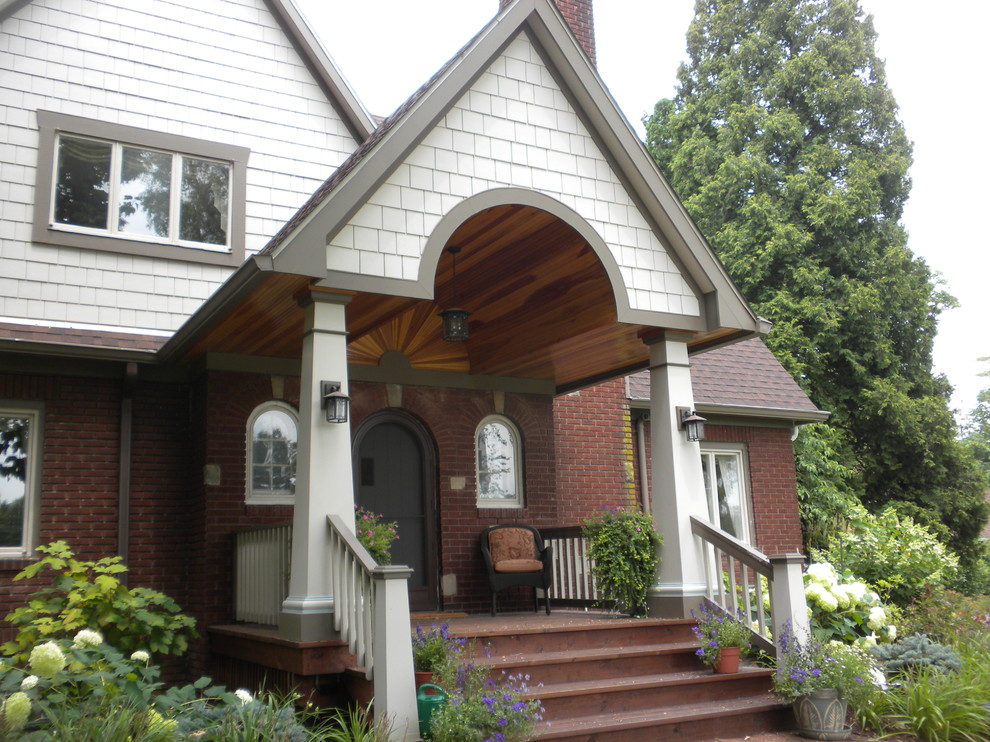Mid-sized classic front porch idea in Cleveland with decking and a roof extension