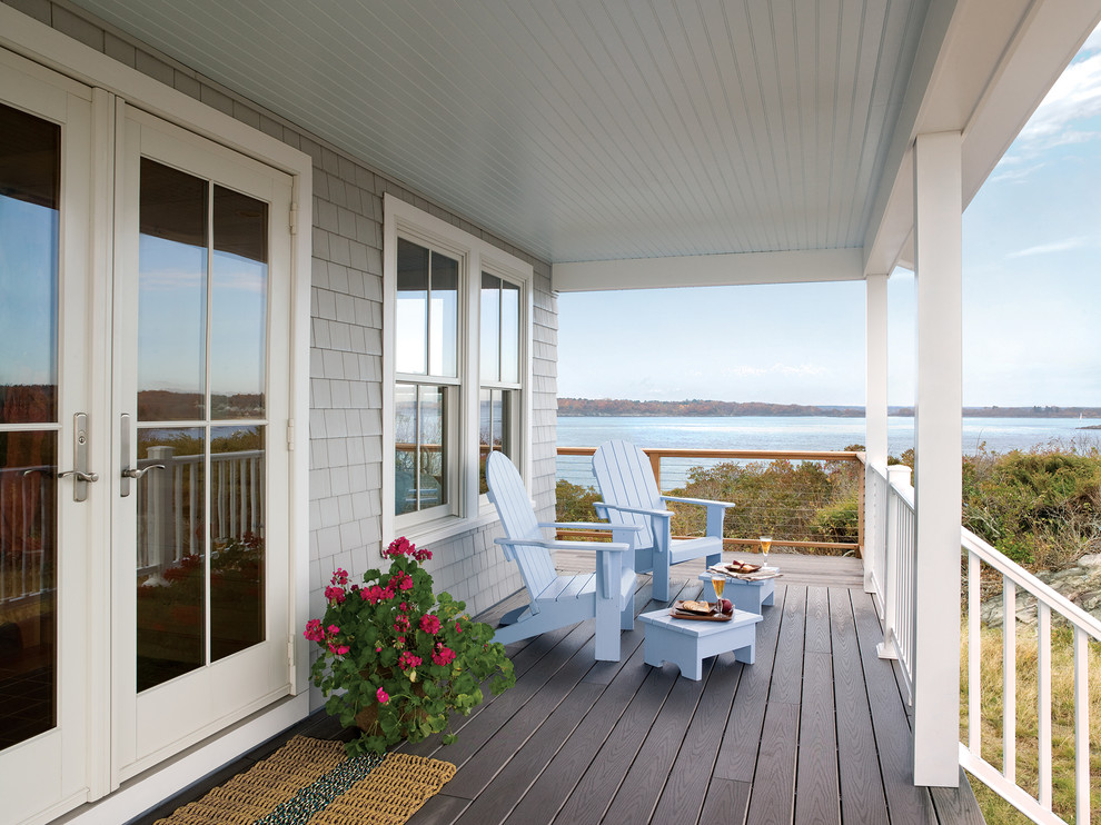 Mid-sized beach style front porch photo in Minneapolis with decking and a roof extension