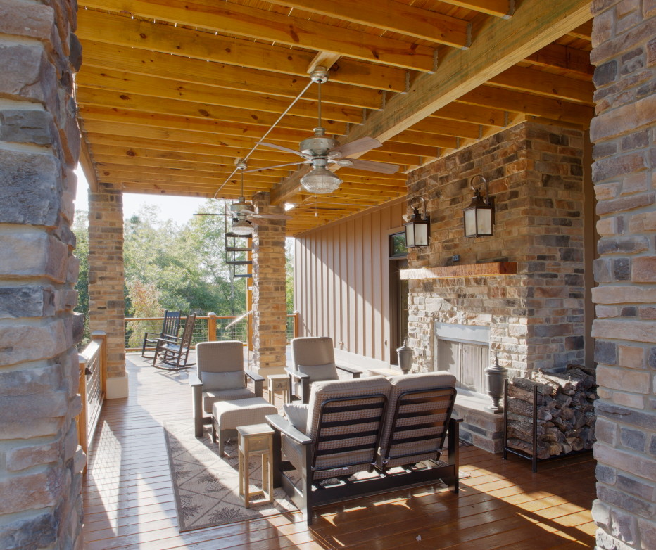 Large arts and crafts back porch idea in Atlanta with a fire pit, decking and a roof extension