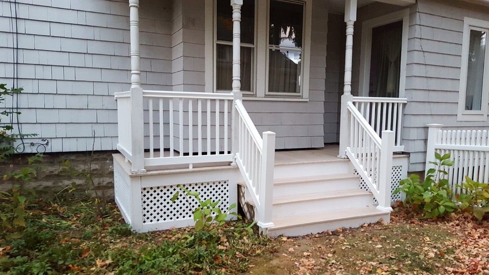 Cette photo montre un porche d'entrée de maison avant chic de taille moyenne avec des pavés en béton et une extension de toiture.