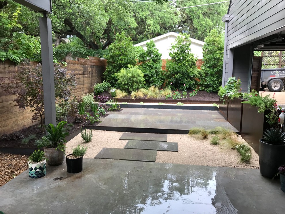Inspiration for a small contemporary stone back porch remodel in Austin