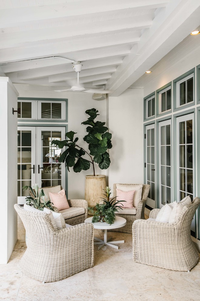 Inspiration for a beach style veranda in Miami with a potted garden and a roof extension.
