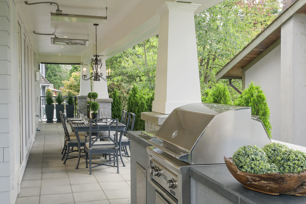 Photo of a classic veranda in Vancouver with a roof extension and a bbq area.